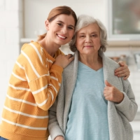 A female and a senior woman smiling
