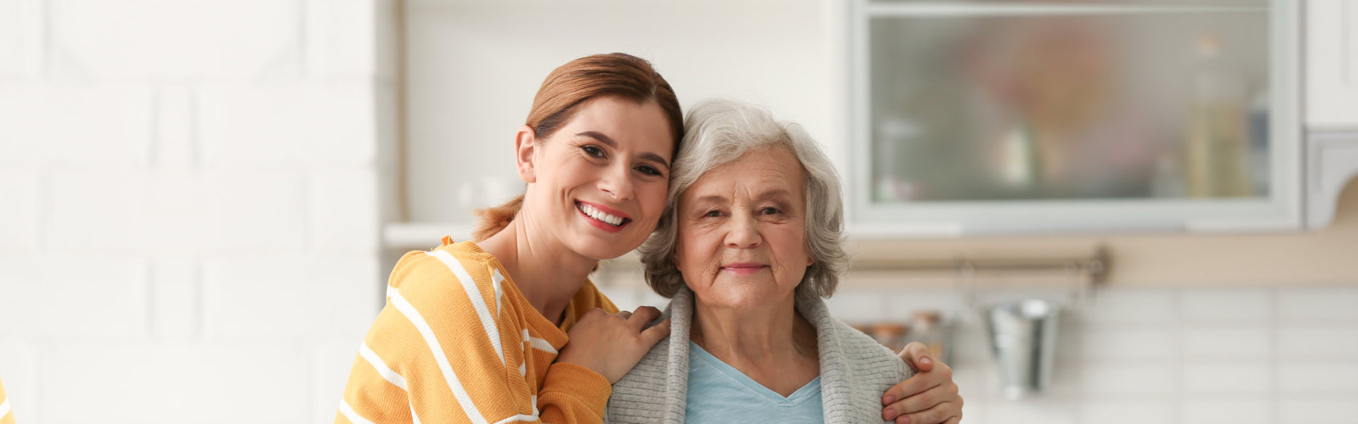 A female and a senior woman smiling